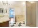 Bathroom with shower, bath, and vanity, with black and white checkered floor tiling at 1331 Abbey Crescent Ln, Clearwater, FL 33759