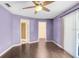 Bedroom with ceiling fan, laminate floors, and two closets at 1331 Abbey Crescent Ln, Clearwater, FL 33759