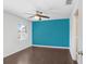 Bright bedroom with a painted accent wall, ceiling fan, wood laminate floors, and a window at 1331 Abbey Crescent Ln, Clearwater, FL 33759