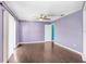 Spacious bedroom featuring wood laminate floors, a ceiling fan, and ample natural light from sliding glass doors at 1331 Abbey Crescent Ln, Clearwater, FL 33759