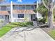 Charming townhouse featuring a two-story facade, well-maintained lawn, and a private driveway at 1331 Abbey Crescent Ln, Clearwater, FL 33759
