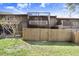 Back exterior view of property with screened-in patio and fenced yard. Townhome with balcony at 1331 Abbey Crescent Ln, Clearwater, FL 33759