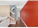 Bright hallway with wood flooring, staircase with white railing and accent wall at 1331 Abbey Crescent Ln, Clearwater, FL 33759