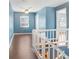 Upstairs hallway with hard wood floors and access to rooms; railing overlooking stairs at 1331 Abbey Crescent Ln, Clearwater, FL 33759
