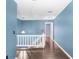 Upstairs hallway with hard wood floors and access to rooms; railing overlooking stairs at 1331 Abbey Crescent Ln, Clearwater, FL 33759