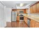 Updated kitchen features wood cabinets, stainless steel appliances, and modern countertops at 1331 Abbey Crescent Ln, Clearwater, FL 33759