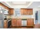 Well-appointed kitchen with stainless steel appliances, ample counter space, and dark wood floors at 1331 Abbey Crescent Ln, Clearwater, FL 33759