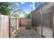 A cozy screened-in patio offering a private retreat with access to a fenced backyard with mature foliage at 1331 Abbey Crescent Ln, Clearwater, FL 33759