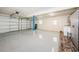 Spacious two car garage with epoxy floor and storage solutions at 13548 Bellewood Ave, Seminole, FL 33776