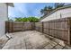 Enclosed patio with tile flooring and wood fence provides a private outdoor space at 13548 Bellewood Ave, Seminole, FL 33776