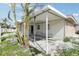 Exterior view of the covered patio and stucco walls, with some vegetation at 15901 Gulf Blvd, Redington Beach, FL 33708