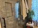 Bathroom featuring a glassed in shower with grey tile and a built in storage niche at 2069 Overbrook Ln, Spring Hill, FL 34606