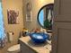 Bathroom featuring a modern vessel sink and toilet, a large mirror, and quirky wall art at 2069 Overbrook Ln, Spring Hill, FL 34606