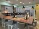 Spacious kitchen features gray cabinets, stainless steel appliances, and an expansive island with seating at 2069 Overbrook Ln, Spring Hill, FL 34606