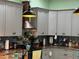 Stylish kitchen with modern appliances, gray cabinetry, and a copper vent hood at 2069 Overbrook Ln, Spring Hill, FL 34606