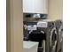 Functional laundry room with modern appliances and storage space at 2069 Overbrook Ln, Spring Hill, FL 34606