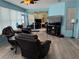 Bright sunroom with multiple seating areas, laminate flooring, ceiling fan and neutral paint at 2069 Overbrook Ln, Spring Hill, FL 34606