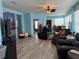 Spacious living room featuring laminate flooring, comfortable seating, and access to the home's other rooms at 2069 Overbrook Ln, Spring Hill, FL 34606