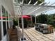 Covered patio featuring outdoor seating under a pergola with lush backyard views at 2069 Overbrook Ln, Spring Hill, FL 34606