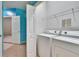 Well-equipped laundry area includes a washer and dryer, with shelving above at 2128 River Turia Cir # 2128, Riverview, FL 33578