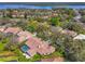 An aerial showing proximity to a lake and lush landscaping, as well as a screened-in pool at 2136 Pinnacle N Cir, Palm Harbor, FL 34684