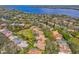 Stunning aerial view of home with a private pool nestled in a lush, green neighborhood near a lake at 2136 Pinnacle N Cir, Palm Harbor, FL 34684