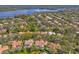 Beautiful aerial shot of a home with pool, surrounded by mature trees in a lakeside community at 2136 Pinnacle N Cir, Palm Harbor, FL 34684