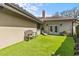 Artificial turf backyard area with bench and lounge chair, a perfect private outdoor space at 2136 Pinnacle N Cir, Palm Harbor, FL 34684