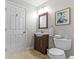 Cozy bathroom featuring a vanity, mirror, and framed artwork for a neat, compact design at 2136 Pinnacle N Cir, Palm Harbor, FL 34684