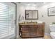 Bathroom with granite countertop vanity, framed mirror, and a door to the outside at 2136 Pinnacle N Cir, Palm Harbor, FL 34684