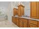 This bathroom features dual vanities, granite counters, mirrors, and ample cabinet storage space at 2136 Pinnacle N Cir, Palm Harbor, FL 34684