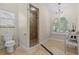 The spacious bathroom includes a walk-in shower and a vanity area with an arched window at 2136 Pinnacle N Cir, Palm Harbor, FL 34684