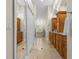 The elegant bathroom is adorned with dual vanities, granite counters, and abundant cabinet space at 2136 Pinnacle N Cir, Palm Harbor, FL 34684