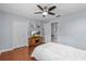 Comfortable bedroom featuring a ceiling fan, closet, and a television on a wicker cabinet at 2136 Pinnacle N Cir, Palm Harbor, FL 34684