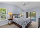 Bedroom with a view of the backyard swimming pool through sliding glass doors at 2136 Pinnacle N Cir, Palm Harbor, FL 34684