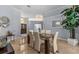 Stylish dining room with a glass table, modern chandelier and neutral color palette at 2136 Pinnacle N Cir, Palm Harbor, FL 34684