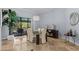 Bright dining room with a glass table, modern chandelier and neutral color palette at 2136 Pinnacle N Cir, Palm Harbor, FL 34684