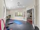 Bright exercise room with rubber flooring, recessed lights, and a wall-mounted TV at 2136 Pinnacle N Cir, Palm Harbor, FL 34684