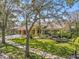 Beautiful single-story home featuring lush landscaping and a well-manicured lawn at 2136 Pinnacle N Cir, Palm Harbor, FL 34684