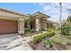 Attractive home facade showcasing the front walkway and vibrant landscaping at 2136 Pinnacle N Cir, Palm Harbor, FL 34684