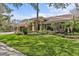 Beautiful single-story home featuring lush landscaping and a well-manicured lawn at 2136 Pinnacle N Cir, Palm Harbor, FL 34684