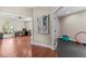 Hallway view to an office with natural light and hardwood floors connecting to an exercise room at 2136 Pinnacle N Cir, Palm Harbor, FL 34684