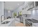 Modern kitchen features stainless appliances and marble countertops at 2136 Pinnacle N Cir, Palm Harbor, FL 34684