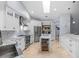 Modern white kitchen with skylight, stainless steel appliances and wine fridge at 2136 Pinnacle N Cir, Palm Harbor, FL 34684