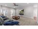 Spacious living room with plush seating, ceiling fan, and mounted TV for a modern and comfortable space at 2136 Pinnacle N Cir, Palm Harbor, FL 34684