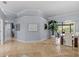 Spacious living area with high ceilings, tile floors, and access to the outdoor dining area at 2136 Pinnacle N Cir, Palm Harbor, FL 34684