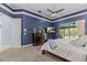 The main bedroom includes a TV, dresser, and a calming view of the pool area at 2136 Pinnacle N Cir, Palm Harbor, FL 34684