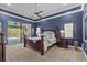 This spacious main bedroom features a four-post bed, pool access, and elegant crown molding at 2136 Pinnacle N Cir, Palm Harbor, FL 34684