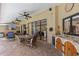 Charming covered patio features a full outdoor kitchen and a dining table, perfect for entertaining at 2136 Pinnacle N Cir, Palm Harbor, FL 34684