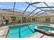 Lovely screened-in pool and spa on a brick patio, located right off the house at 2136 Pinnacle N Cir, Palm Harbor, FL 34684